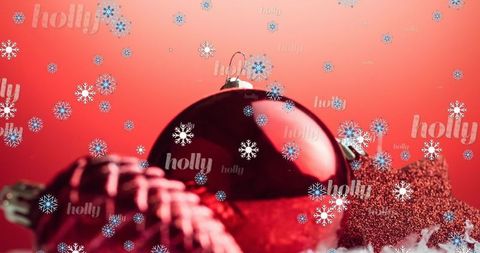 Red holiday ornament with snow and pinecone on red background