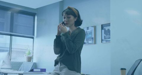 Successful businesswoman engaged in mobile communication at modern office