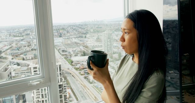Woman Enjoying Coffee While Looking Out City Window - Download Free Stock Images Pikwizard.com