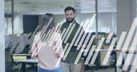 Coworkers discussing project through striped frosted glass in modern open-plan office