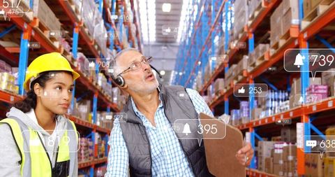 Warehouse workers utilizing technology in logistics management