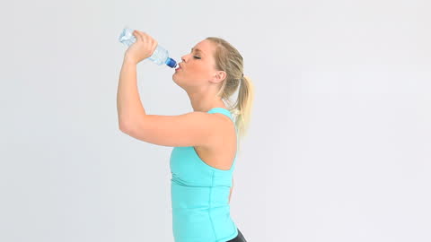 Athletic Woman Rehydrating with Water After Exercise