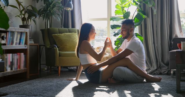 Young Couple Enjoying Afternoon at Home in Sunlit Living Room - Download Free Stock Images Pikwizard.com