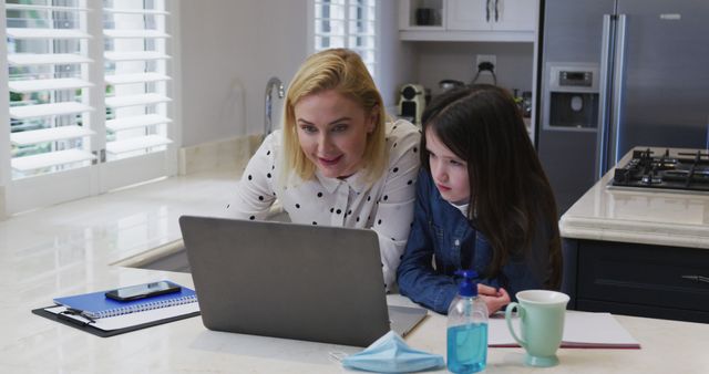 Mother and Daughter Using Laptop at Kitchen Counter - Download Free Stock Images Pikwizard.com