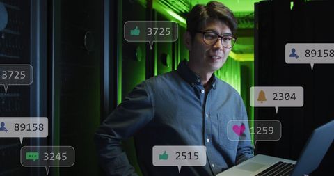Engineer analyzing data with social media metrics in server room