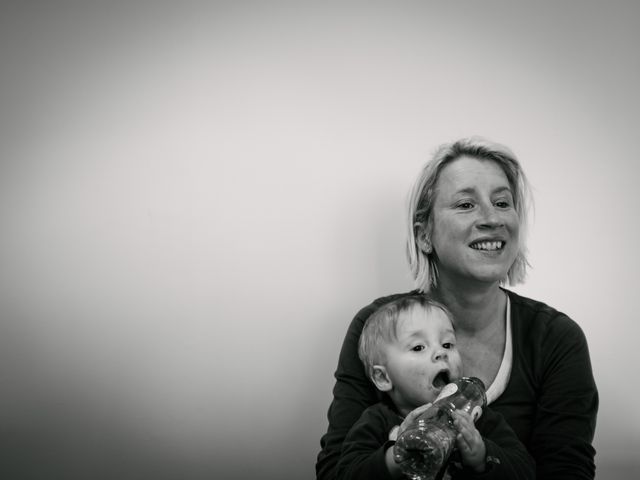 Smiling Mother Holding Baby with Bottle in Monochrome - Download Free Stock Photos Pikwizard.com