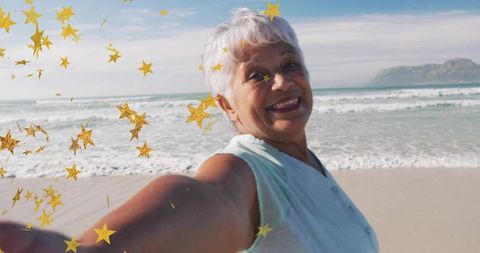 Senior Woman Enjoying Beach with Playful Star Confetti Overlay
