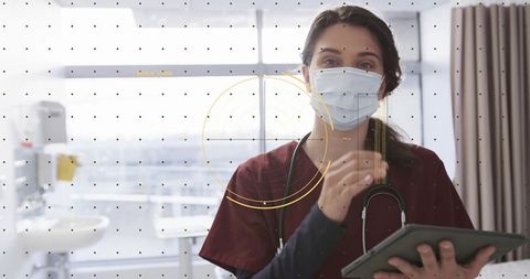 Nurse reviewing tablet with hud overlay in hospital room, wearing mask and stethoscope