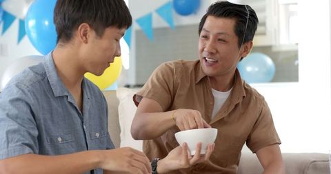 Family Bonding with Father and Son Relaxed at Home Gathering