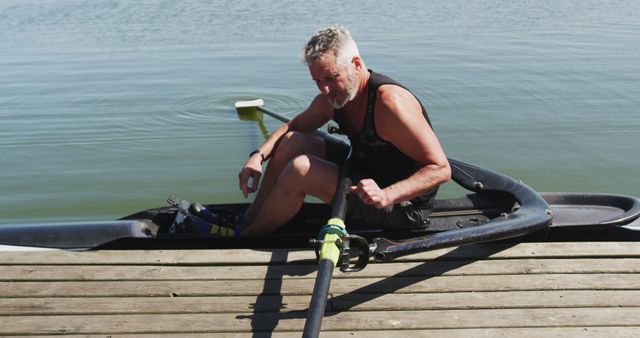 Senior Man Preparing Rowing Boat on Dock by Lake - Download Free Stock Images Pikwizard.com