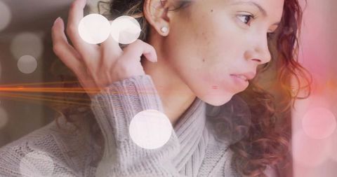 Pensive Woman Gazing Near Window in Cozy Sweater