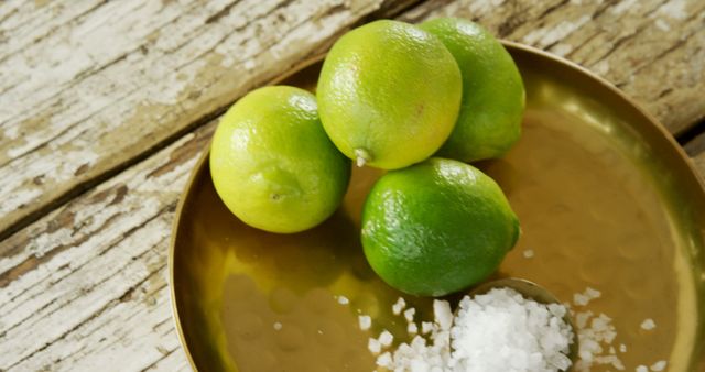 Green Lemon Limes on Gold Tray with Coarse Sea Salt on Rustic Wooden Table - Download Free Stock Images Pikwizard.com