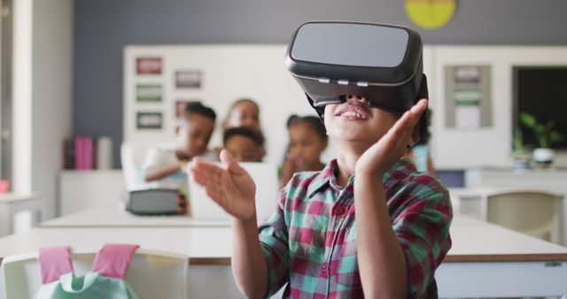 Young African American boy enjoying virtual reality in a classroom setting wearing a VR headset while his friends watch. Perfect for themes related to education technology, immersive learning, future classrooms, and innovative teaching methods.