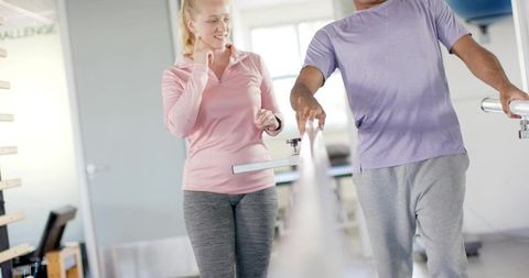 Rehabilitation walking training on parallel bars with wearable tracker and therapist