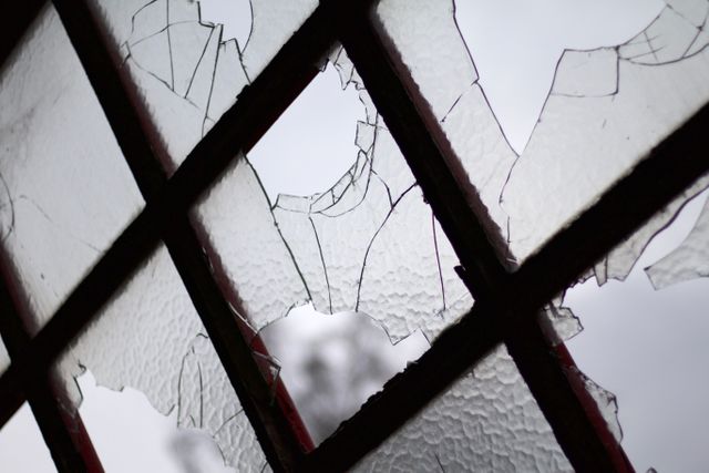 Close-Up of Broken Window Panes in Overcast Light - Download Free Stock Photos Pikwizard.com