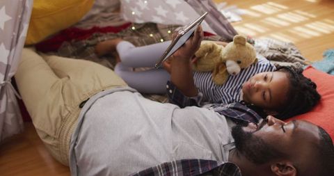 Father and Daughter Bonding at Home Using Tablet