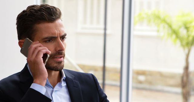 Business Professional Talking on Phone in Modern Office - Download Free Stock Images Pikwizard.com