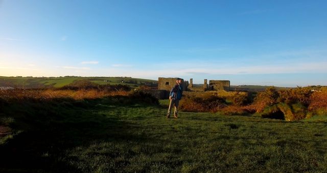 Hiker Exploring Ruins in Countryside at Dawn - Download Free Stock Images Pikwizard.com