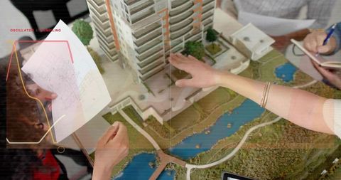 Architectural scale model showing urban high-rise masterplan with team collaboration