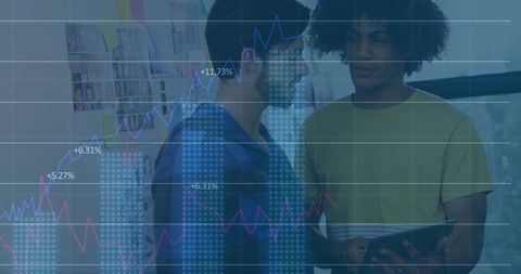 Male Professionals Strategizing with Tablet Over Business Charts