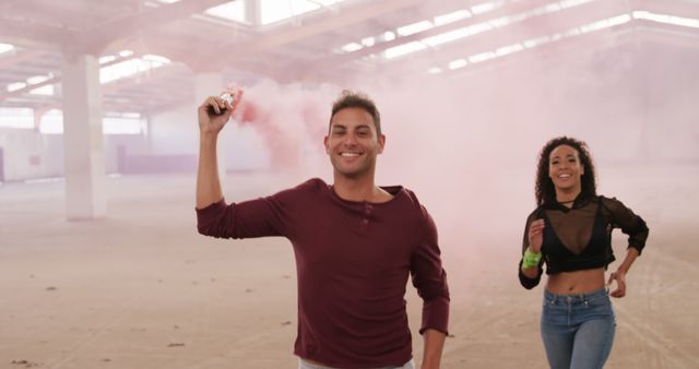 Smiling Man and Happy Woman Playing with Smoke Bomb indoors - Download Free Stock Images Pikwizard.com