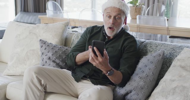 Senior man excited while looking at smartphone during Christmas - Download Free Stock Images Pikwizard.com
