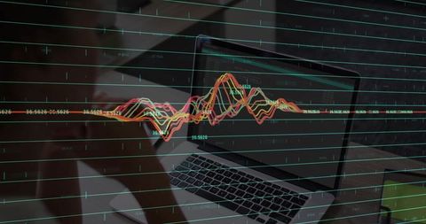 Businesswoman Analyzing Line Chart on Laptop at Work Desk