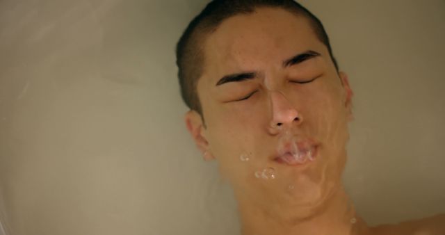 Relaxing Person Submerged in Water with Closed Eyes - Download Free Stock Images Pikwizard.com