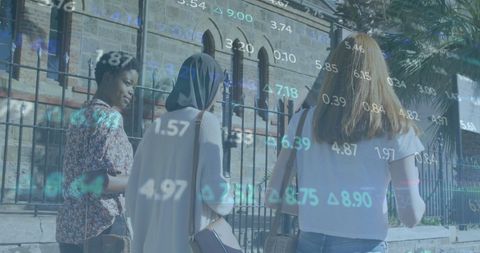 Diverse Women Walking in City with Financial Data Overlay