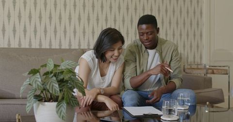 Couple planning wedding details together at home