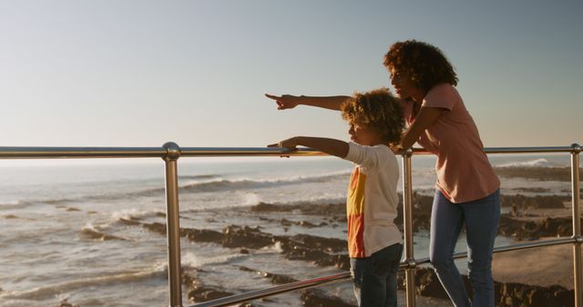 Mother and Child Standing on Pier, Enjoying Ocean View - Download Free Stock Images Pikwizard.com