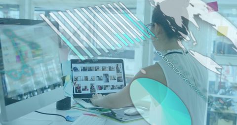 Businesswoman Analyzing Data on Laptop with Digital Graphics