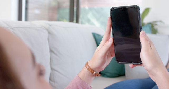 Person Using Smartphone While Relaxing on Couch at Home - Download Free Stock Images Pikwizard.com