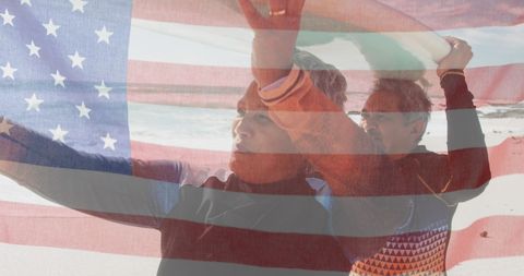 Patriotic Senior Couple with American Flag on Beach