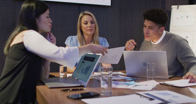 Diverse Team Collaborating Over Business Report in Office Meeting Room - Download Free Stock Images Pikwizard.com