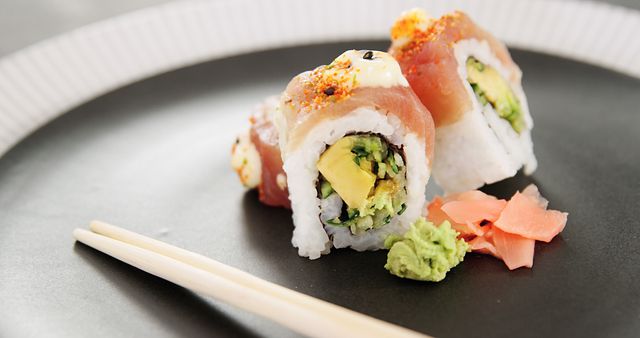 Sushi Roll with Avocado, Wasabi and Pickled Ginger on Black Plate - Download Free Stock Images Pikwizard.com