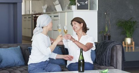 Senior Women Celebrating with Champagne in Cozy Living Space