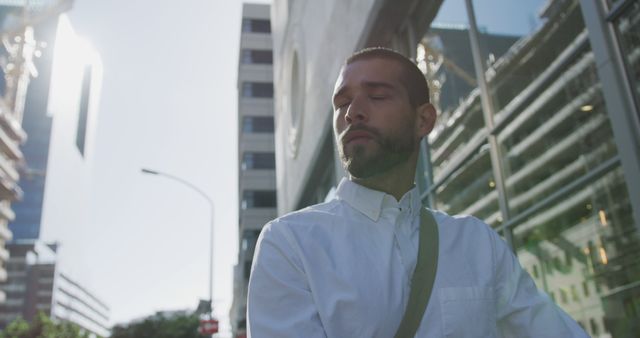 Businessman Relaxing Walk on Urban Street in Bright Sunlight - Download Free Stock Images Pikwizard.com