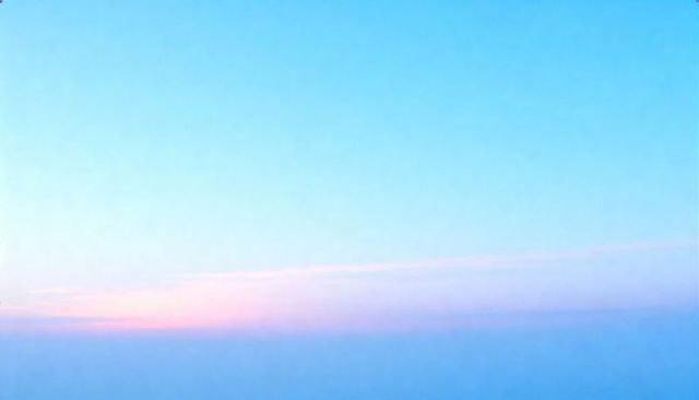 Pastel Dawn Sky Gradient Featuring Thin Cloud Band and Hazy Horizon for Minimal Background