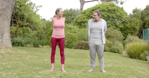 Senior Couple Enjoying Outdoor Exercise in Garden