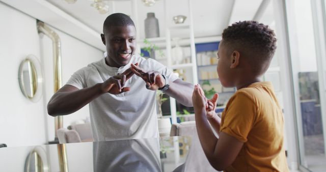 Father and Son Engaging in Sign Language Communication at Home - Download Free Stock Images Pikwizard.com