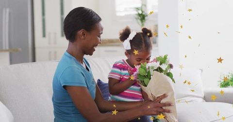 Mother and Daughter Sharing a Tender Moment with Flowers at Home