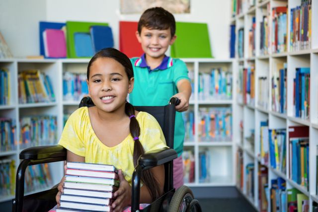 Children in a school library, one girl in a wheelchair holding books while a boy stands behind her. This image can be used for educational materials, promoting inclusivity and diversity in schools, or library programs. It highlights themes of friendship, teamwork, and the joy of reading.
