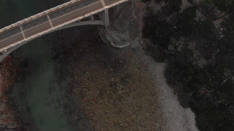 Scenic Aerial View of Coastal Bridge and Rocky Shoreline