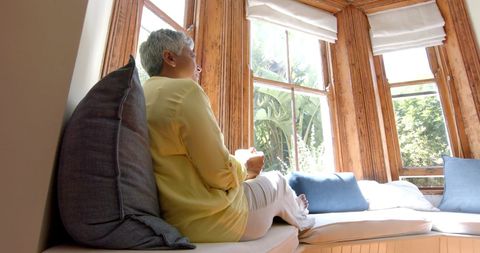 Content Senior Woman Enjoying Tea by Sunny Window Seat - Download Free Stock Images Pikwizard.com