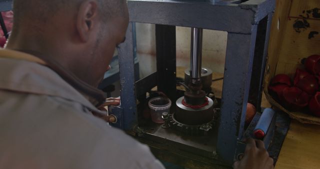 Worker operating industrial juice pressing machine - Download Free Stock Images Pikwizard.com