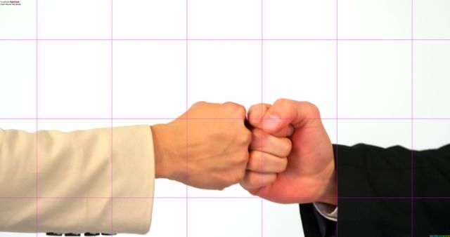 Two individuals, businessmen, are engaging in a fist bump, with copy space. This gesture often signifies agreement, teamwork, or a casual greeting in a professional setting.