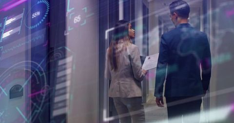 Suited Professionals Analyzing Holographic Charts in Office Hallway
