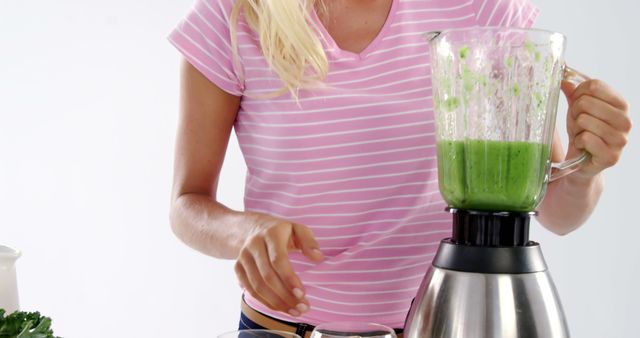 Woman Making Green Smoothie in Blender Wearing Pink Shirt - Download Free Stock Images Pikwizard.com