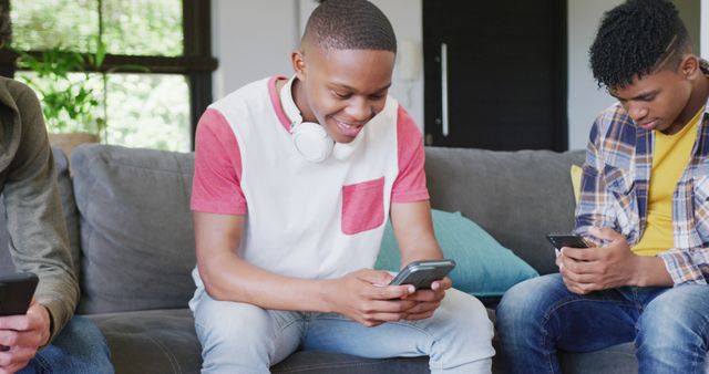 Teenagers Sitting on Couch Using Smartphones Together - Download Free Stock Images Pikwizard.com